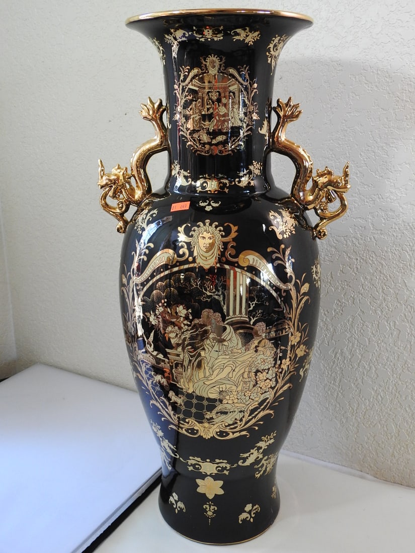 Large Neoclassical Black and Gold Porcelain Vase: Large neoclassical porcelain vase with black ground, floral decoration, and 24K gold-painted accents. Approx. 24 x 12 x 9.5 in.