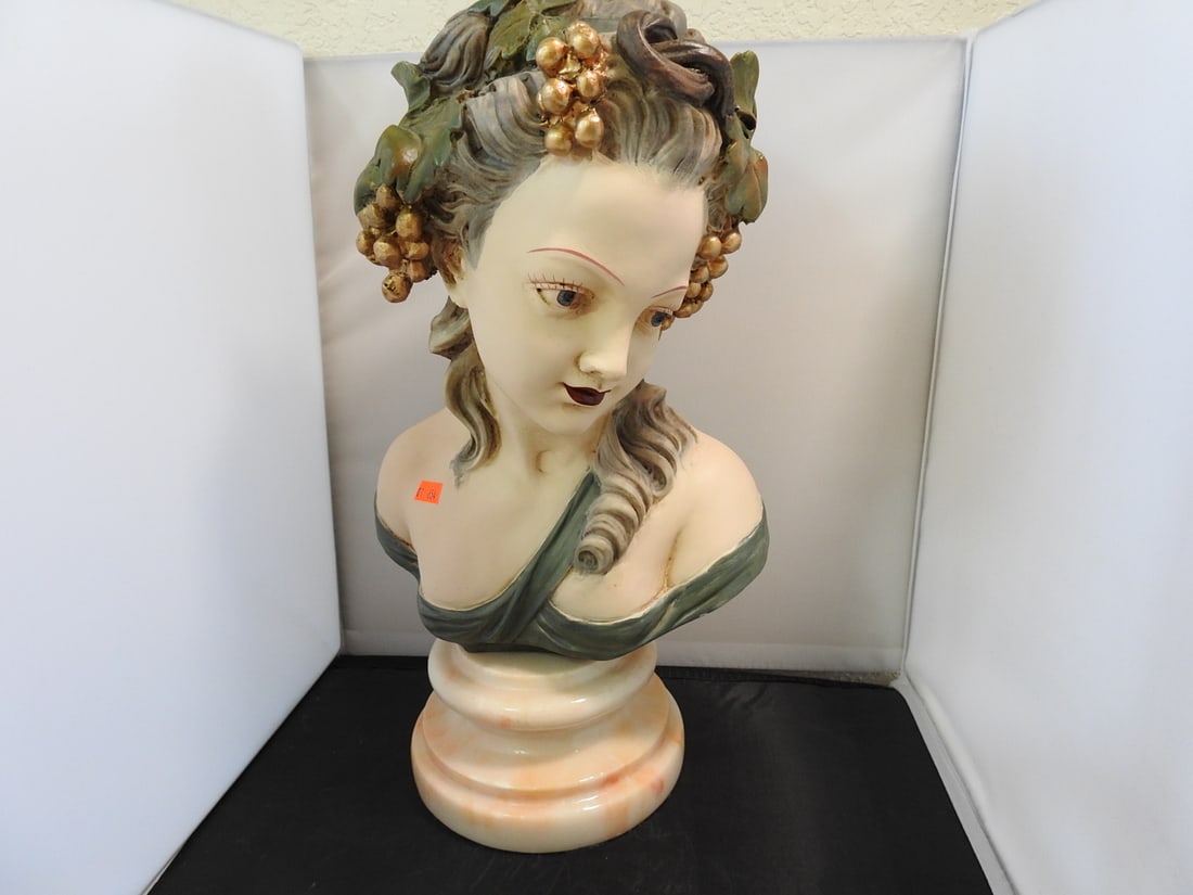 French Girl Bust on Marble Base: Painted plaster French girl bust mounted on a marble base with floral headpiece detail. Approx. 16.25 x 9 x 7.5 in.