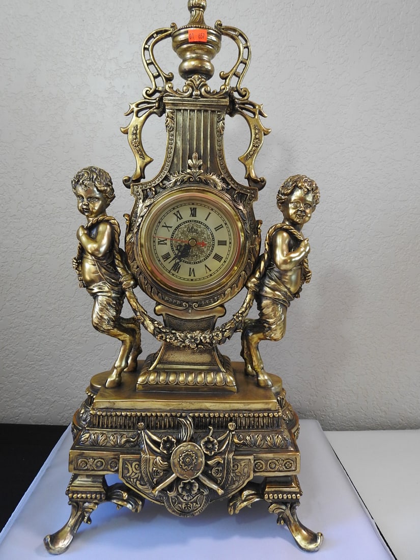 Design Toscano Grande Chateau Beaumont Mantel Clock: Design Toscano Grande Chateau Beaumont mantel clock in cast metal with antiqued gold finish and ornate classical decoration. Battery operated. Approx. 23.75 x 11.75 x 9 in.