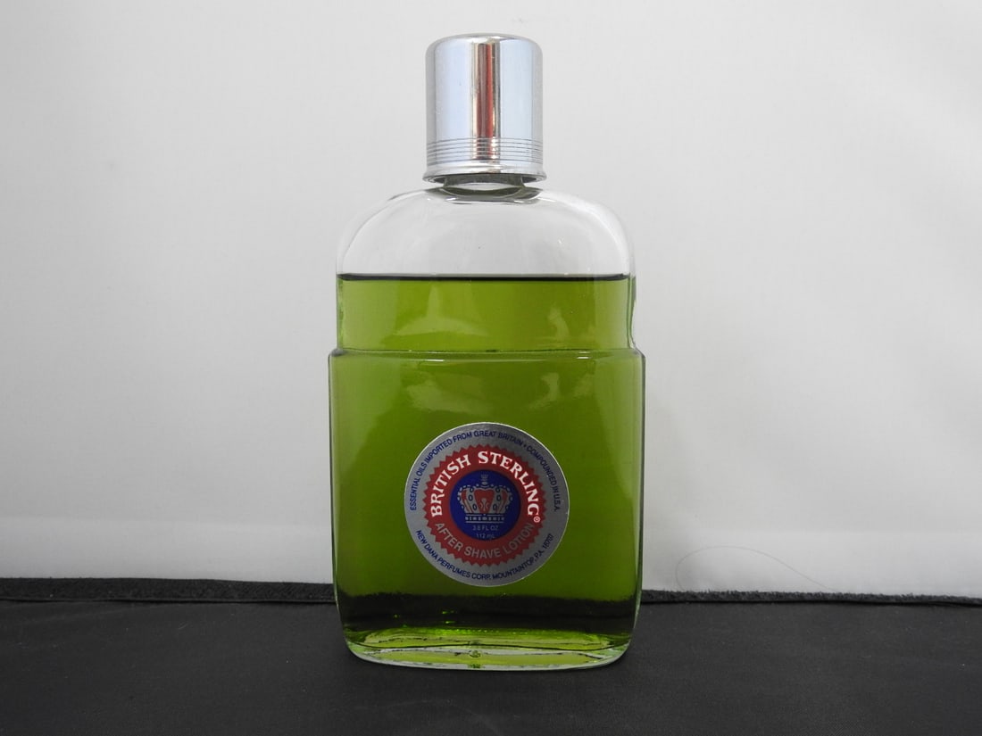 British Sterling After Shave Splash by Dana: British Sterling after shave splash by Dana in green glass bottle with silver-tone cap. Approx. 5.75 x 3 x 1.15 in.