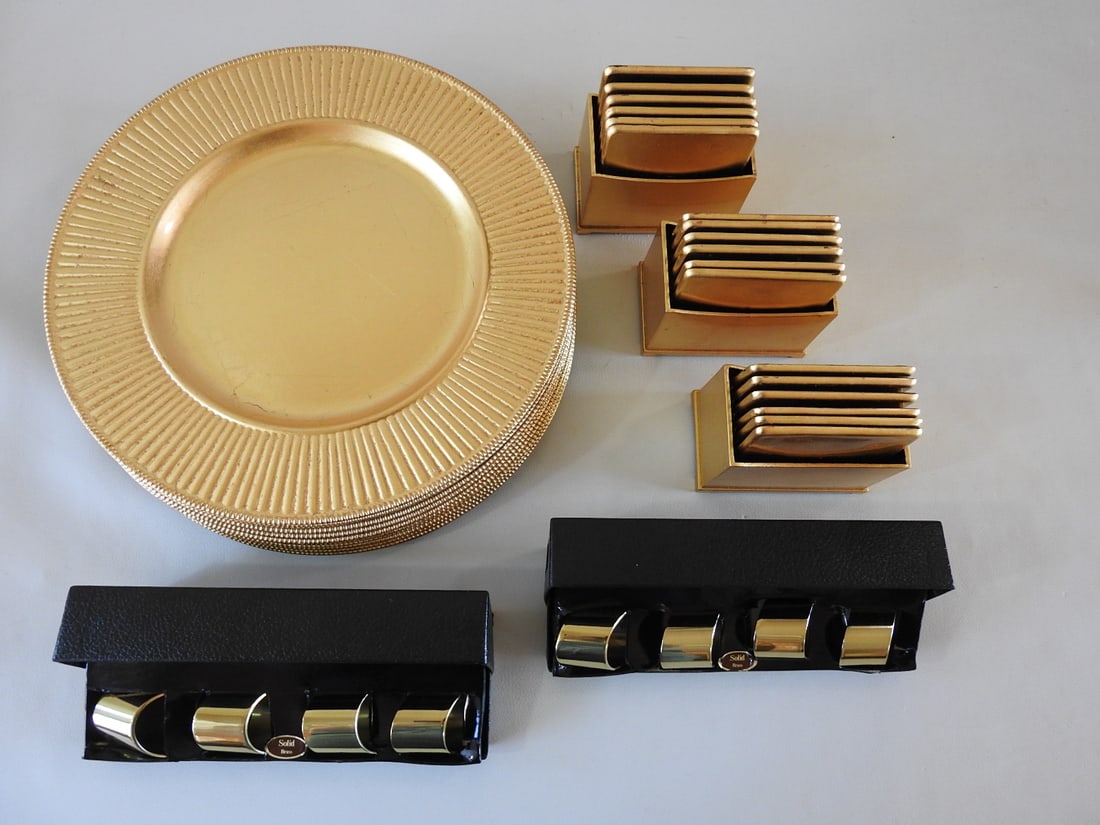 Dinner Entertainment Accessories Group with Chargers & Napkin Rings: Dinner entertainment accessories group including 12 gold-tone chargers, 18 coasters, and two sets of four napkin rings. Includes gold gilt hard plastic and brass-tone pieces. Measured as a group.