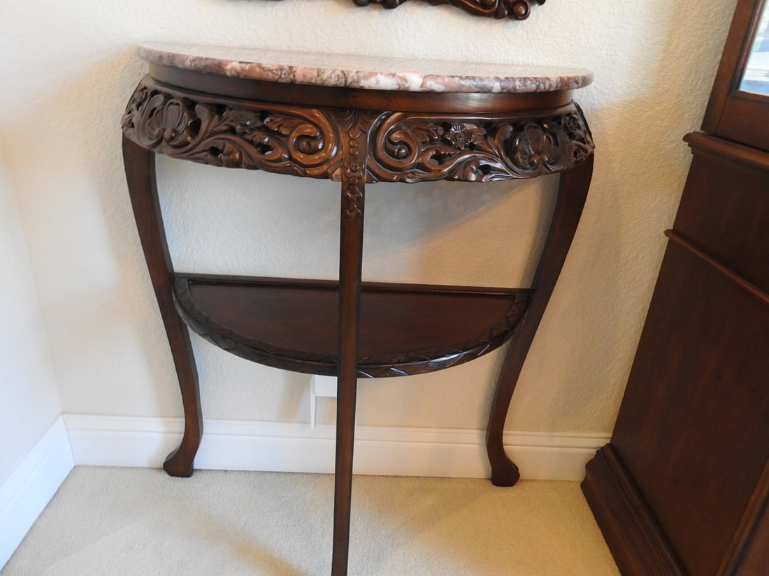 Rococo Style Half-Moon Console Table with Marble Top: Rococo style half-moon console table with two-tier form, carved mahogany frame, and Breccia Pernice marble top. Approx. 35.25 x 29 x 13.5 in.