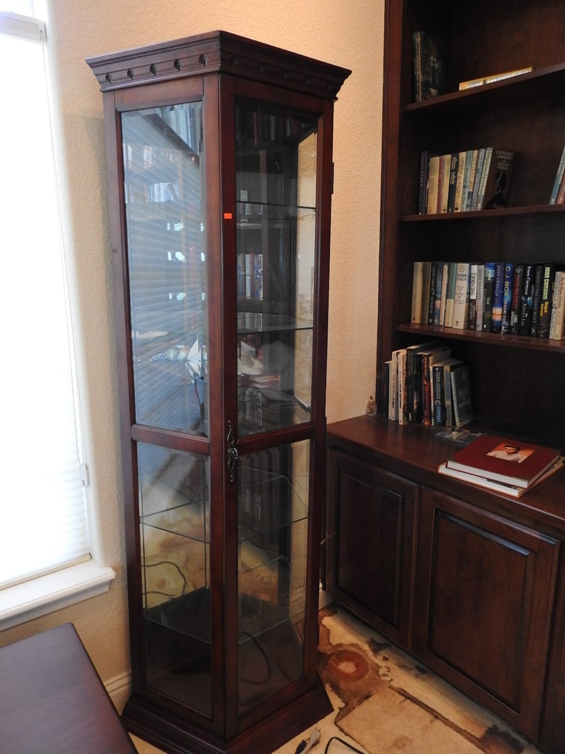 Cherry Finish Lighted Curio Cabinet: Cherry finish curio cabinet with pebbled/tempered glass, mirror backing, interior lighting, glass shelves, and half-hexagon form. Approx. 74.5 x 25 x 14.5 in.