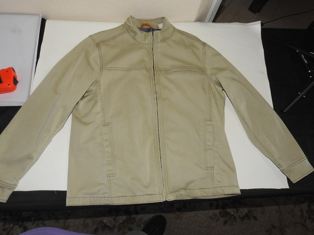 Tommy Bahama Large Khaki Coat: Tommy Bahama large khaki coat with cotton/spandex shell and 100% cotton lining. Measured as packed. Approx. 3.5 x 16.5 x 13 in.