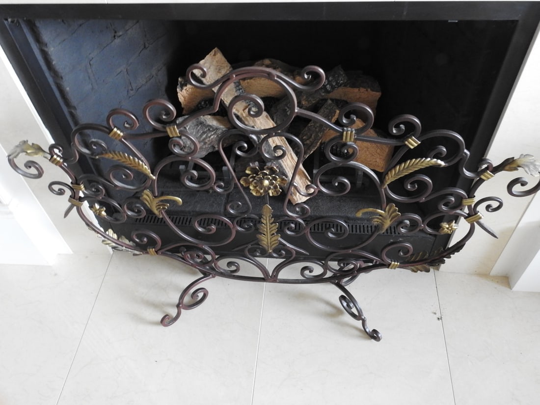Classical Style Scroll Metal Fireplace Screen: Classical style metal fireplace screen with black finish, ornate scrollwork, and decorative leaf/acanthus accents. Approx. 27.5 x 39.5 x 9 in.