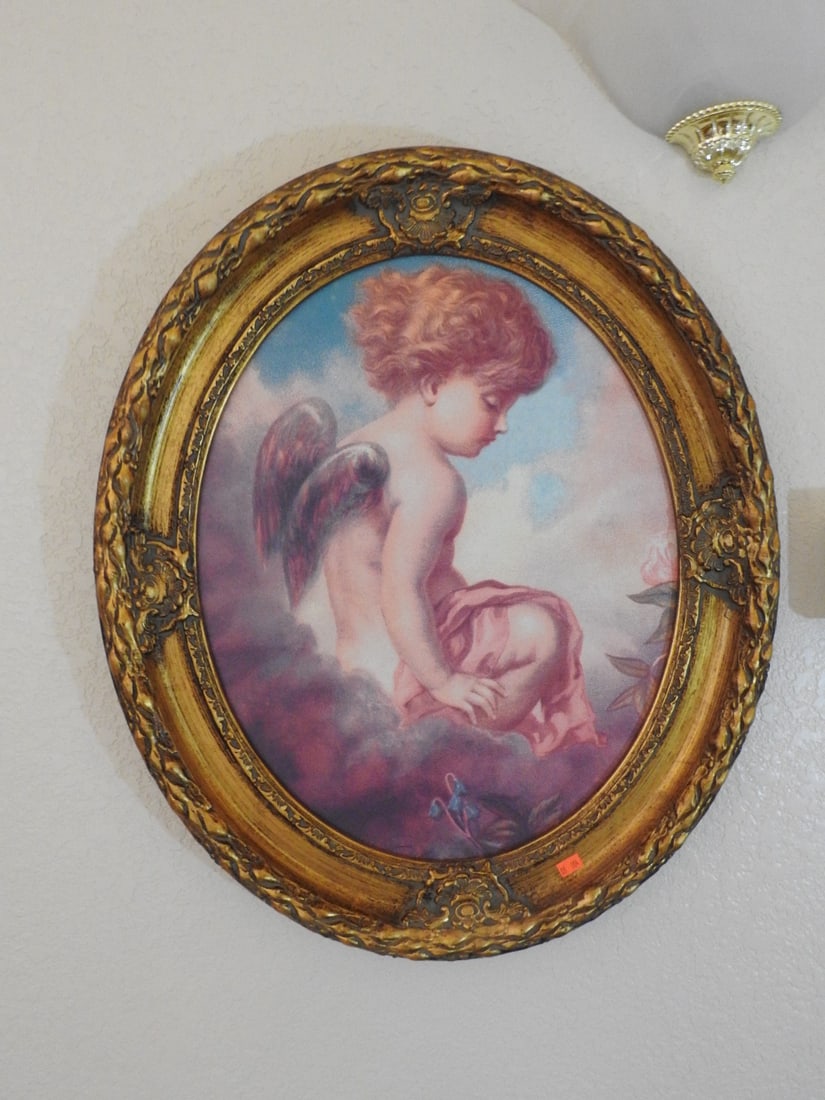 “Daydreams?? Victorian Style Lithograph Print: Victorian style lithograph print titled Daydreams, depicting a cherub/angel child, housed in an oval gilt frame. Approx. 26 x 22 x 3 in.