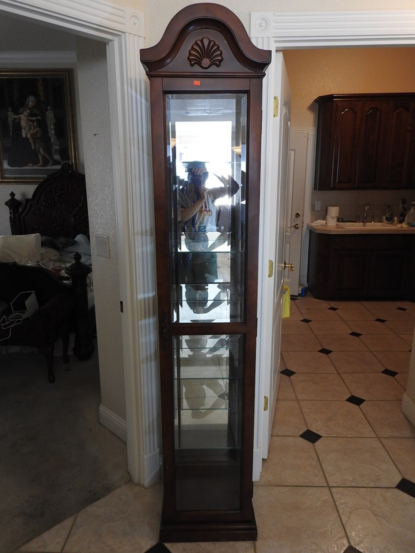 Classical Style Tall Glass Curio Cabinet: Classical style tall glass curio cabinet with wood frame, glass door and side panels, mirror back, and glass shelving. Approx. 81 x 17 x 15 in.