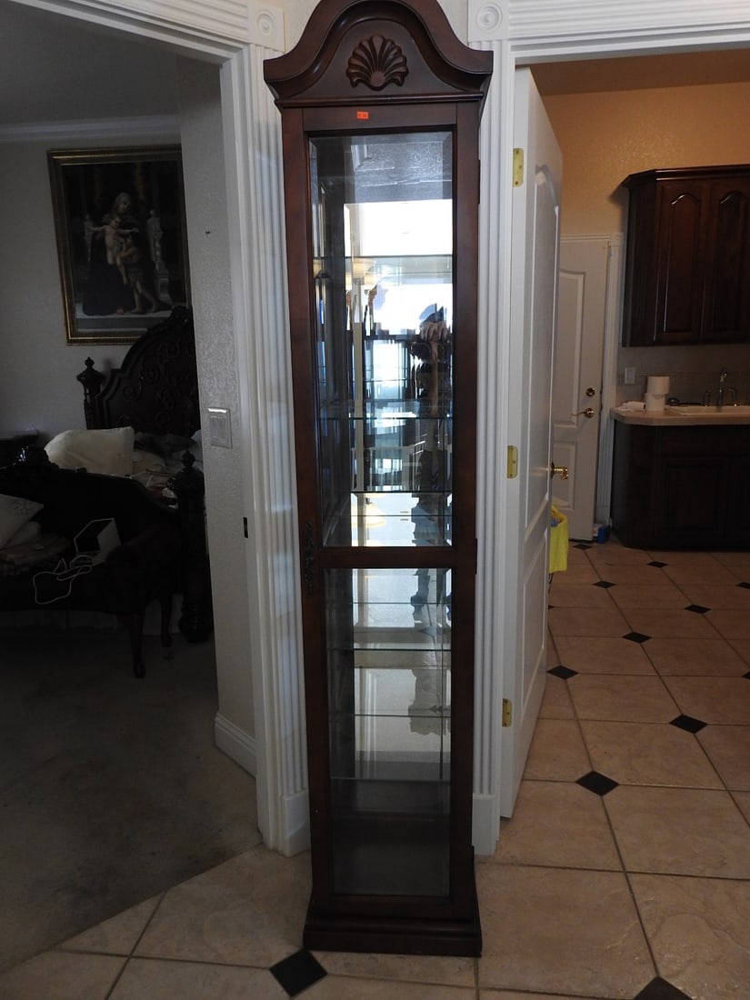 Classical Style Tall Glass Curio Cabinet: Classical style tall glass curio cabinet with wood frame, glass door and side panels, mirror back, and glass shelving. Made in China label visible. Approx. 81 x 17 x 15 in.