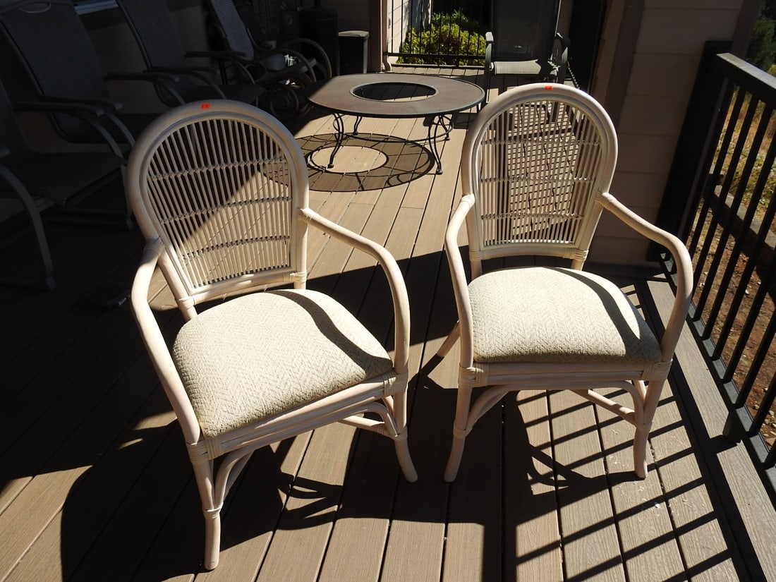 Pair of Bamboo & Rattan Armchairs: Pair of bamboo and rattan armchairs with upholstered seats and backs. Individual chair dimensions approx. 38 x 24 x 25 in.; listed dimensions are packed/as a pair. Approx. 38 x 48 x 25 in.