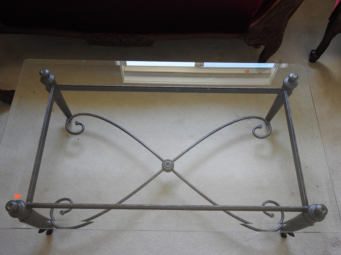 Classical Roman Style Metal & Glass Coffee Table: Classical Roman style coffee table with metal scroll base, glass top, and ball finial accents. Approx. 19 x 49 x 29 in.