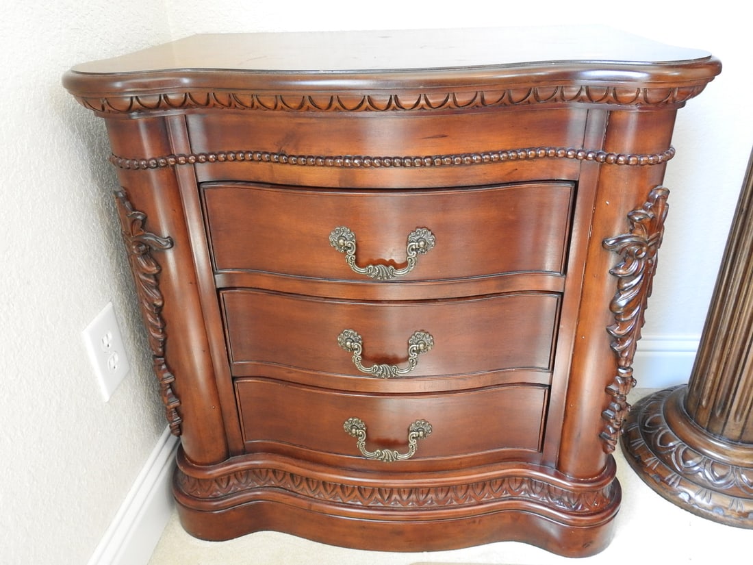 Classical Style Carved Mahogany Nightstand with Drawers: Classical style carved mahogany nightstand with shaped marble-look top, drawer storage, and ornate carved details. Approx. 31 x 31 x 19 in.