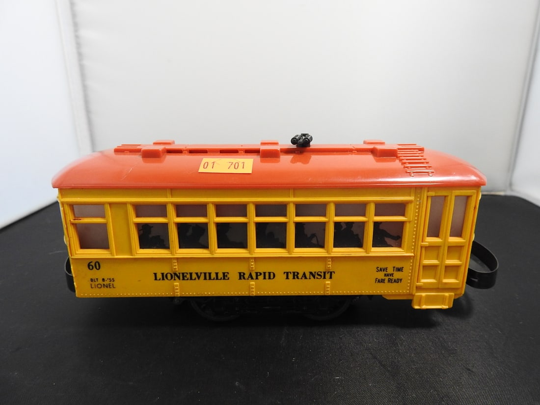 Lionel No. 60 Lionelville Rapid Transit Trolley: Lionel postwar-era O gauge No. 60 Lionelville Rapid Transit trolley in yellow/orange with roof details, window graphics, and metal/plastic construction. Circa 1950s Lionel production; operation not fu