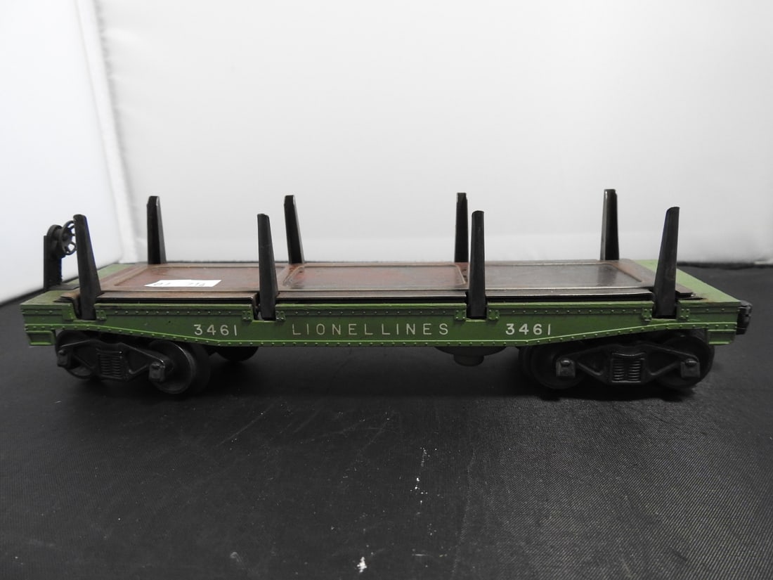Lionel No. 3461 Operating Log Unloading Car: Lionel postwar-era O gauge No. 3461 operating log unloading flatcar with green deck, black stakes, and log-unloading mechanism. Circa 1950s Lionel production; operating feature not fully tested