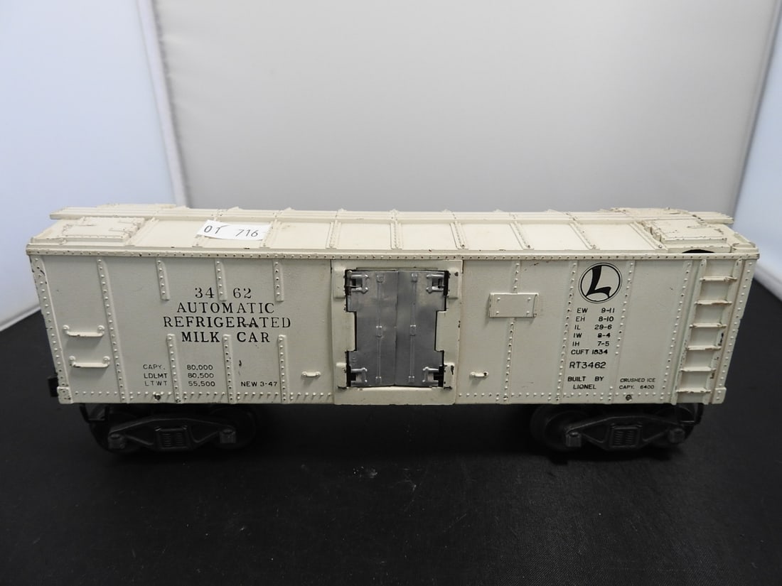 Lionel No. 3462 Automatic Refrigerated Milk Car: Lionel postwar-era O gauge No. 3462 automatic refrigerated milk car with white body, opening side doors, milk-car graphics, and interior milk-can area. Circa 1950s Lionel production; operating