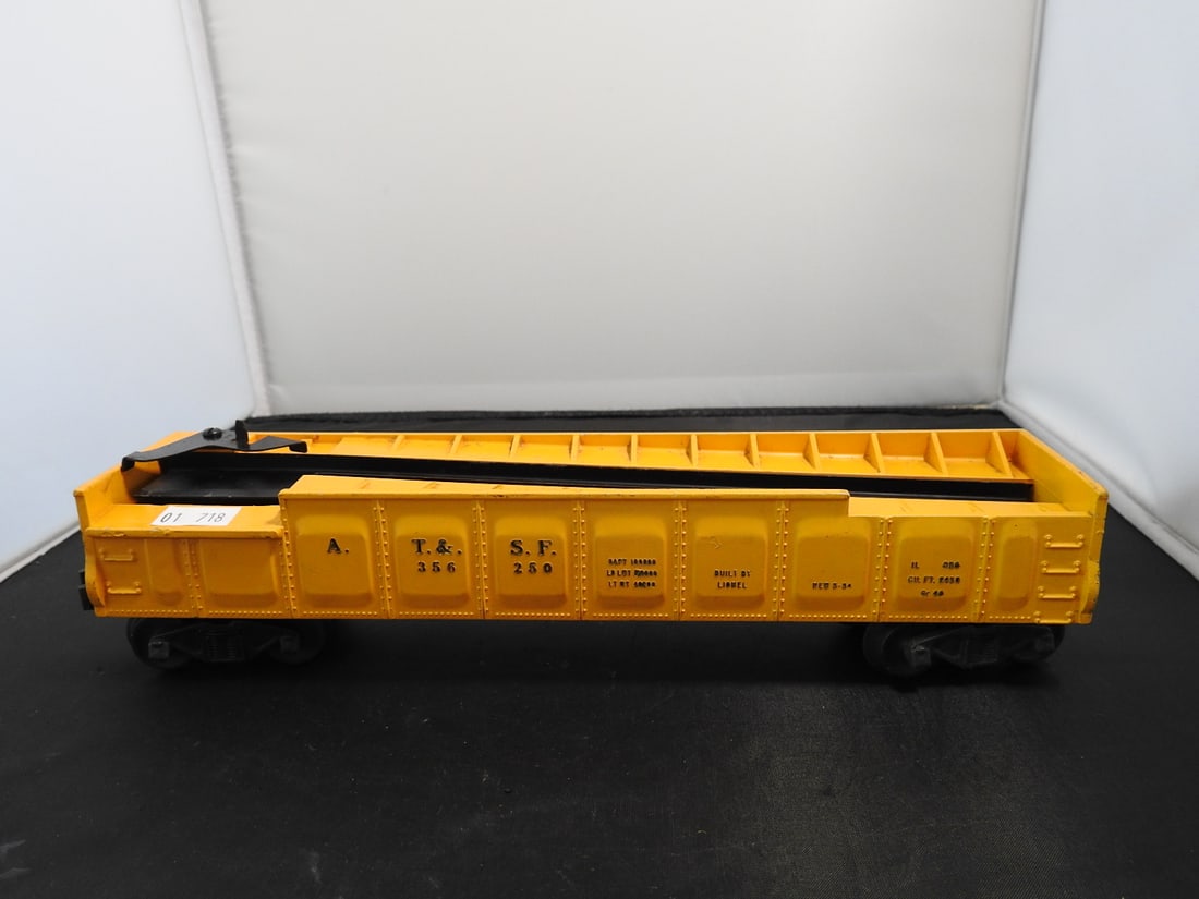 Lionel No. 3562-50 AT&SF Operating Barrel Car: Lionel postwar-era O gauge No. 3562-50 Atchison, Topeka & Santa Fe operating barrel car with yellow body, open barrel-car form, and black frame. Circa 1950s Lionel production; barrels/operating