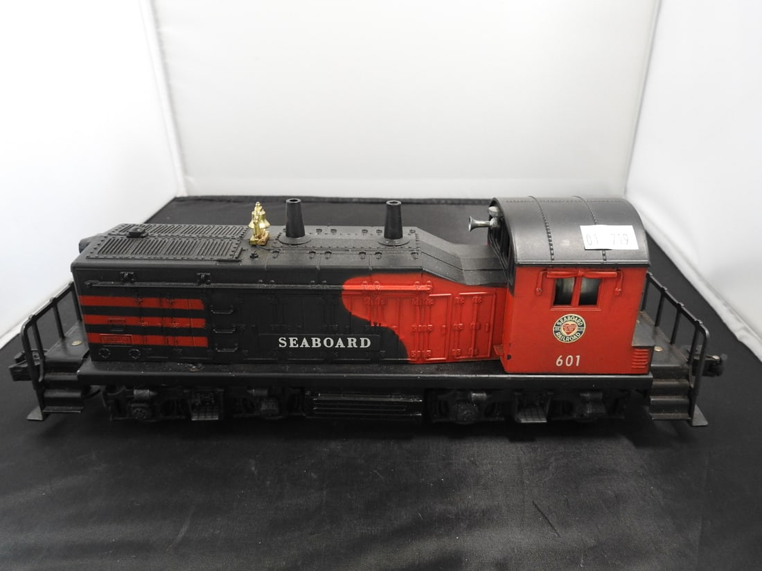 Lionel No. 601 Seaboard NW-2 Diesel Switcher: Lionel postwar-era O gauge No. 601 Seaboard NW-2 diesel switcher locomotive with red and black body, Seaboard markings, and metal/plastic construction. Circa 1950s Lionel production; operation not