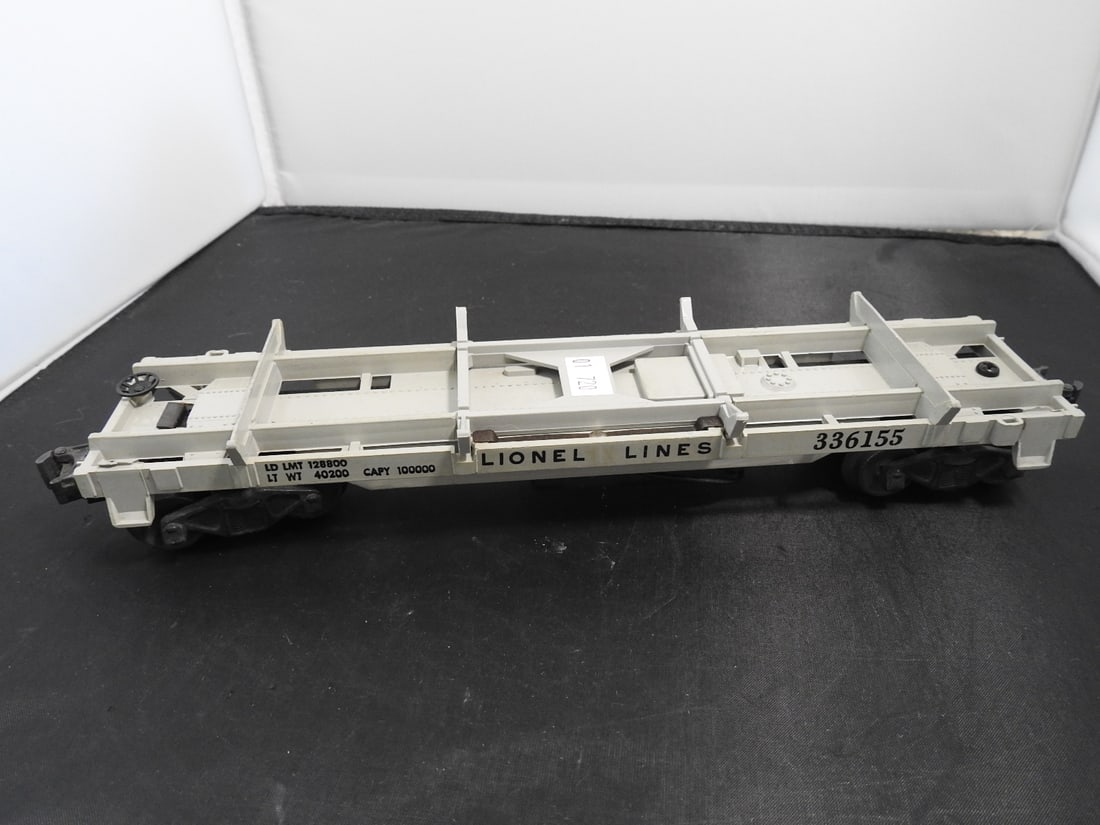 Lionel No. 3361 Operating Log Unloading Flatcar: Lionel postwar-era O gauge No. 3361 operating log unloading flatcar with white/grey frame, log stakes, and unloading mechanism. Circa 1950s Lionel production; operating feature not fully tested unless