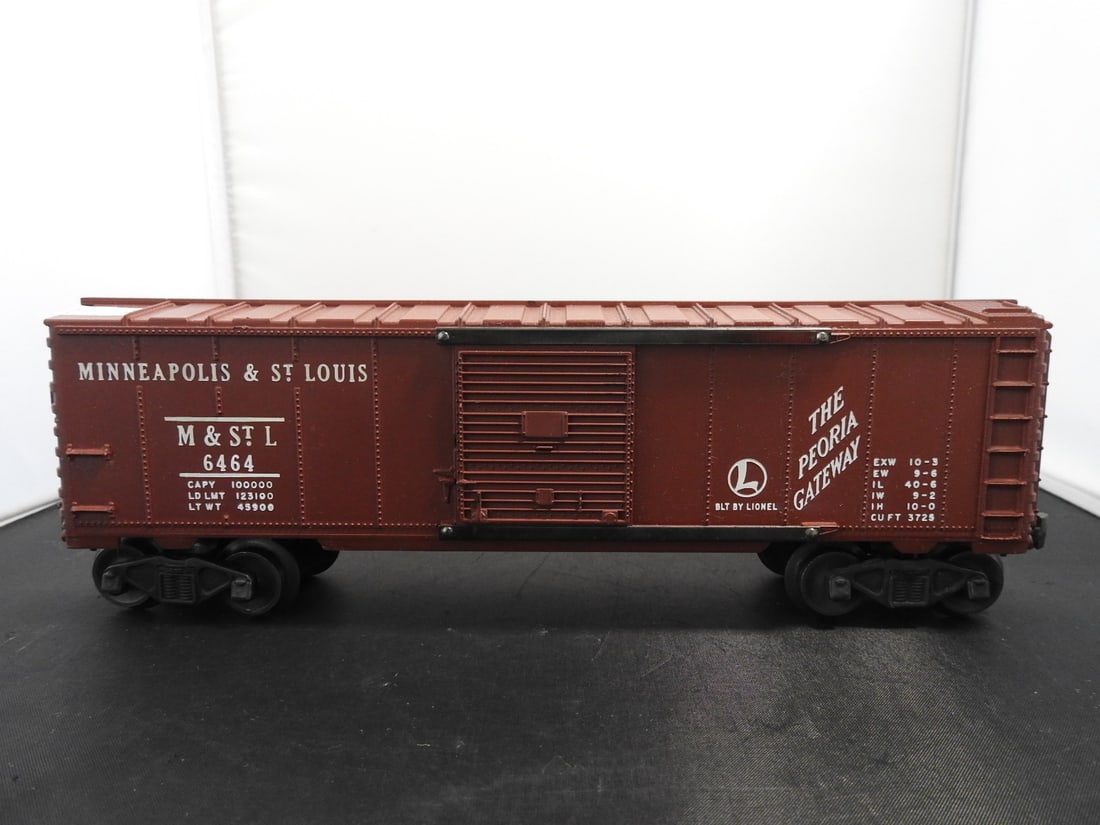 Lionel No. 6464 Minneapolis & St. Louis Boxcar: Lionel O gauge No. 6464 Minneapolis & St. Louis boxcar with brown body, sliding door, M&StL markings, and 'The Peoria Gateway' lettering. Postwar-era, 1950s-style Lionel boxcar. Approx. 3.5 x 11 x 3