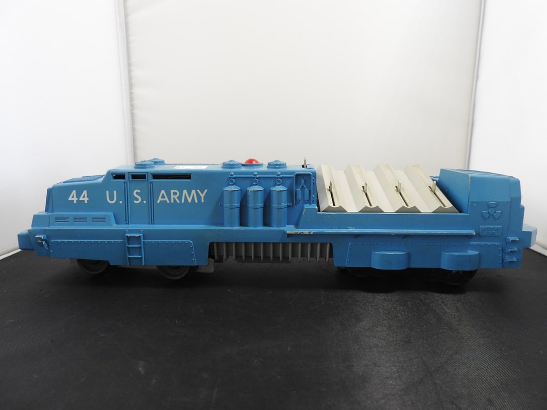 Lionel No. 44 U.S. Army Missile Launcher Locomotive: Lionel O gauge No. 44 U.S. Army missile launcher locomotive in blue with No. 44 side marking, white launcher section, military/radioactive graphics, and plastic/metal construction. 1960s