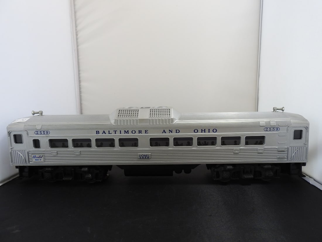 Lionel No. 2559 Baltimore & Ohio RDC Passenger Car: Lionel O gauge No. 2559 Baltimore & Ohio RDC passenger car with silver body, B&O lettering, roof detail, window silhouettes, and Lionel 2559 markings. Mid-century/postwar-style rail diesel car