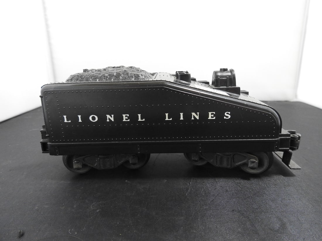 Lionel Lines Black Coal Tender: Lionel O gauge black Lionel Lines coal tender with molded coal load, black trucks, and operating coupler. Postwar-era, 1950s-style tender; exact catalog number not visible in photos and whistle functi