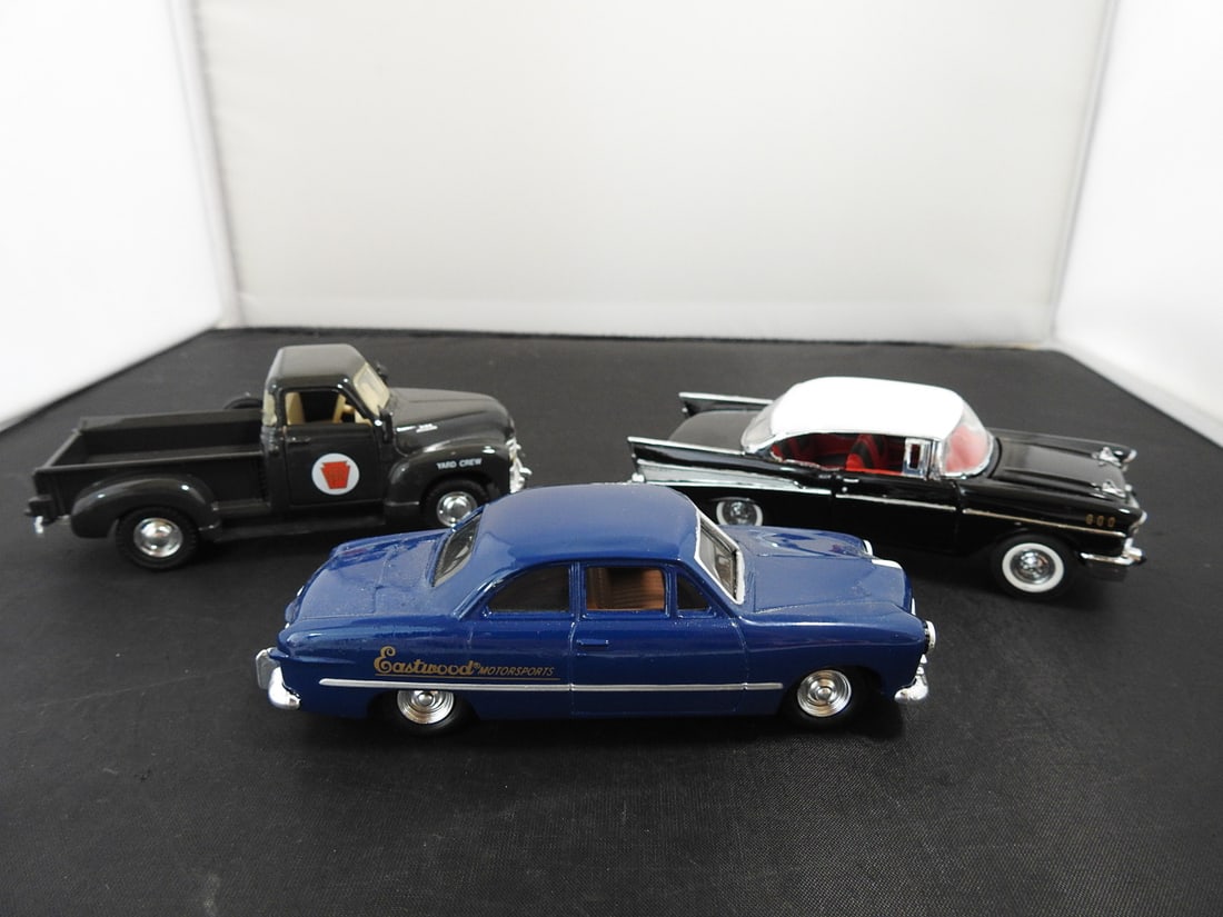 Lot of Three Die-Cast Classic Cars: Lot of three die-cast classic vehicles including a black Pennsylvania Railroad yard crew pickup, blue Eastwood Motorsports coupe, and black/white 1950s-style hardtop car. Late 20th to early 21st-centu