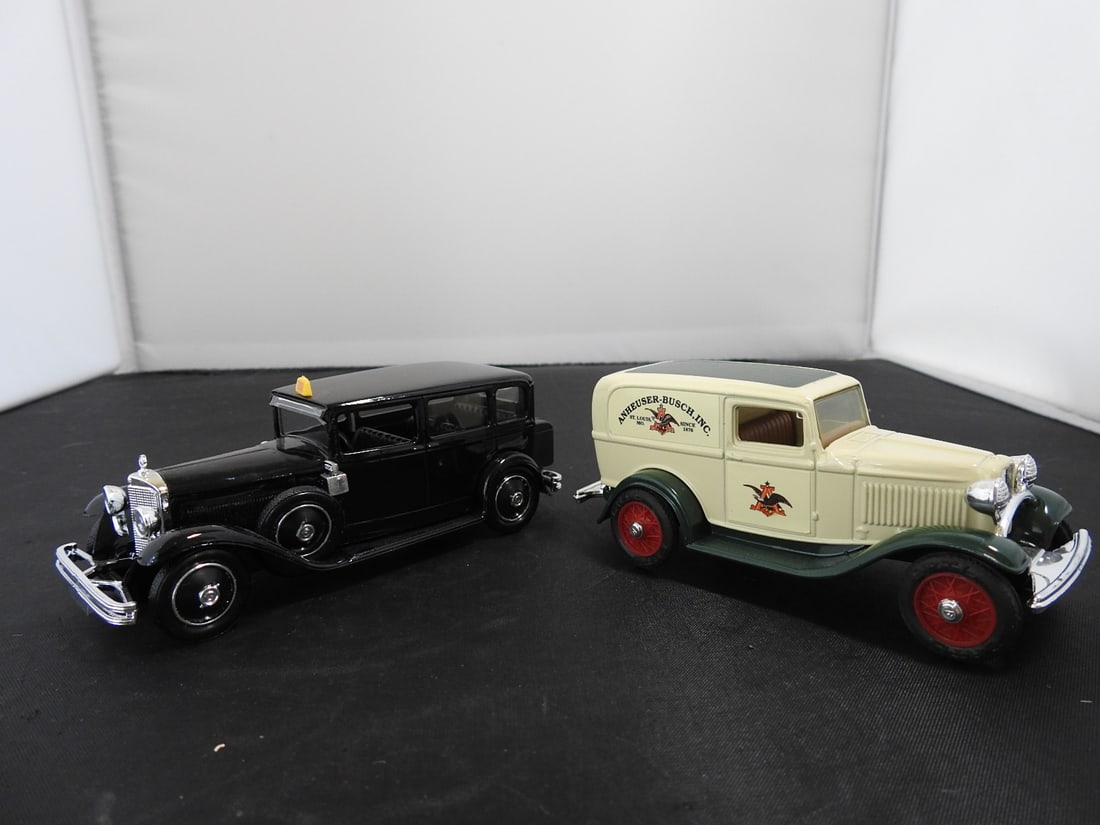 Pair of Vintage-Style Die-Cast Service Vehicles: Pair of vintage-style die-cast service vehicles, including a black sedan / limousine-style car and a cream-and-green delivery van. Late 20th century collectible die-cast pieces. Measured as packed. Ap