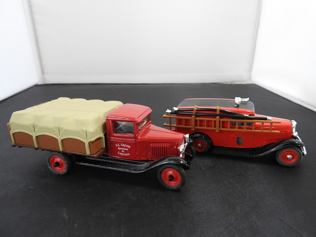 Pair of Vintage-Style Red Die-Cast Service Vehicles: Pair of vintage-style red die-cast service vehicles, including a canvas-covered truck and a fire/rescue style wagon. Late 20th century collectible die-cast pieces. Measured as packed. Approx. 2.25 x