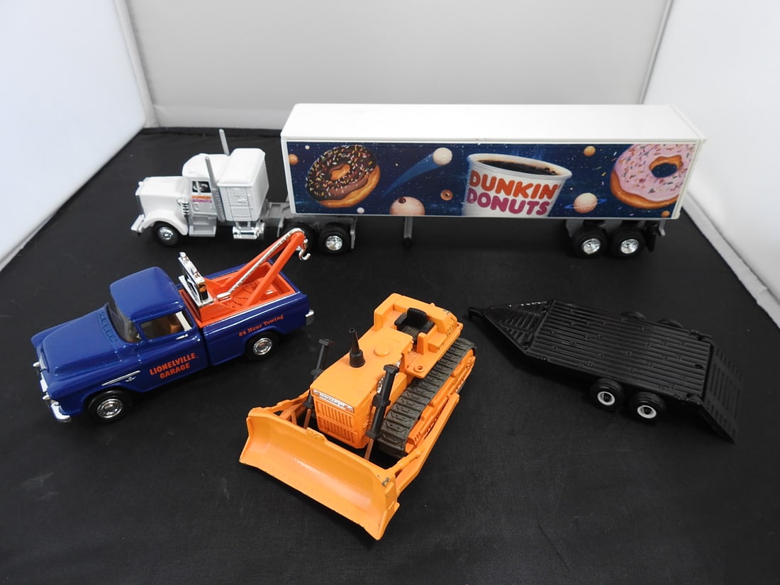 Mixed Lot of Die-Cast and Plastic Vehicle Toys: Mixed late 20th century toy vehicle lot including die-cast and plastic vehicles such as a blue 427 roadster, motorcycle, Louisville Garage tow truck, Dunkin' Donuts tractor-trailer, bulldozer, and tra