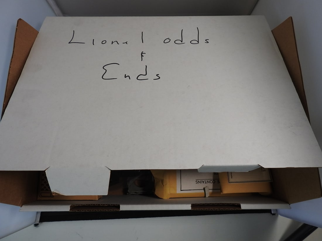 Lionel Reference Guides, Accessory Boxes and Cleaning Equipment Lot: Mixed Lionel reference and accessory lot including Greenberg's Guide to Lionel Trains volumes, accessories/equipment boxes, lighted billboard boxes, cleaning/lubrication kit items, and assorted small 