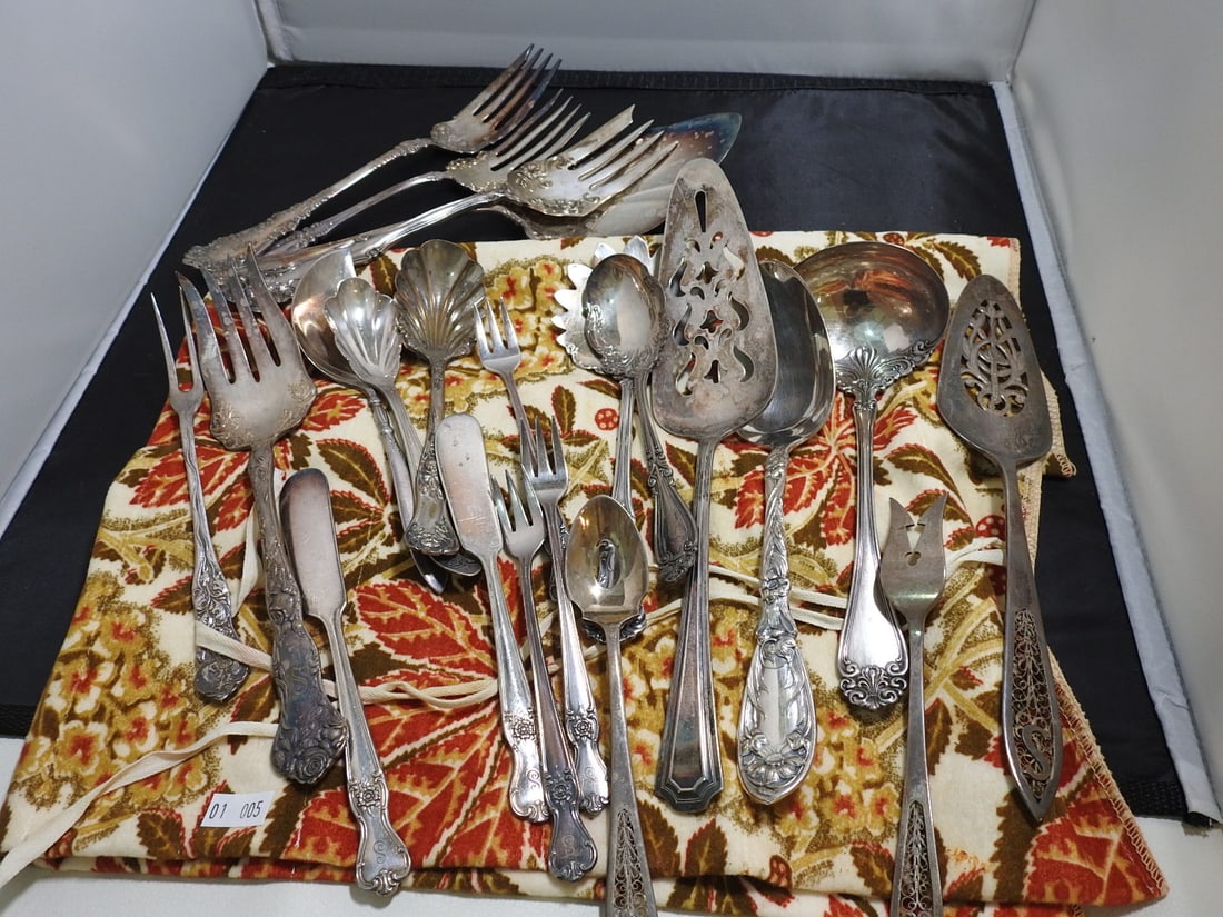 Antique Silver Flatware and Serving Utensil Lot, 22 Pieces: 22-piece antique silver-tone flatware and serving utensil lot including forks, spoons, shell-form serving pieces, pierced servers, and assorted decorative pieces. Silver content not verified. Approx. 
