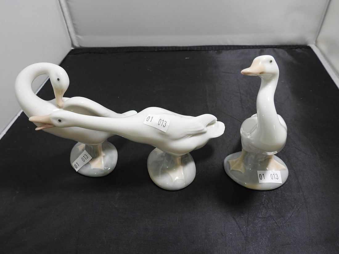 Lladro Fine Geese Porcelain Figures, Set of 3: Set of 3 Lladro porcelain geese figures in glossy white finish, including goose family forms. Approx. 5 x 7 x 5 in.