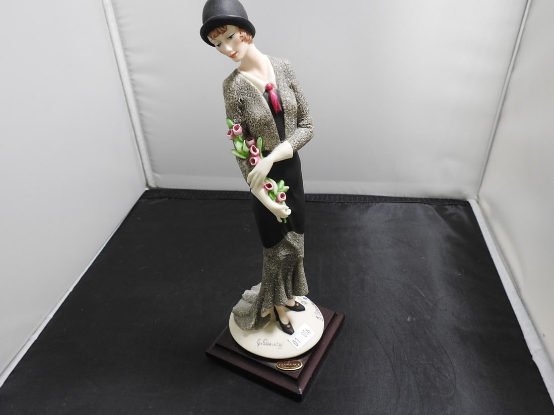 Giuseppe Armani Florence Figurine on Wood Base: Florence / Giuseppe Armani resin figure on wood base, copyright 1987, depicting a stylish woman holding flowers. Approx. 10.5 x 3.5 x 3.5 in.