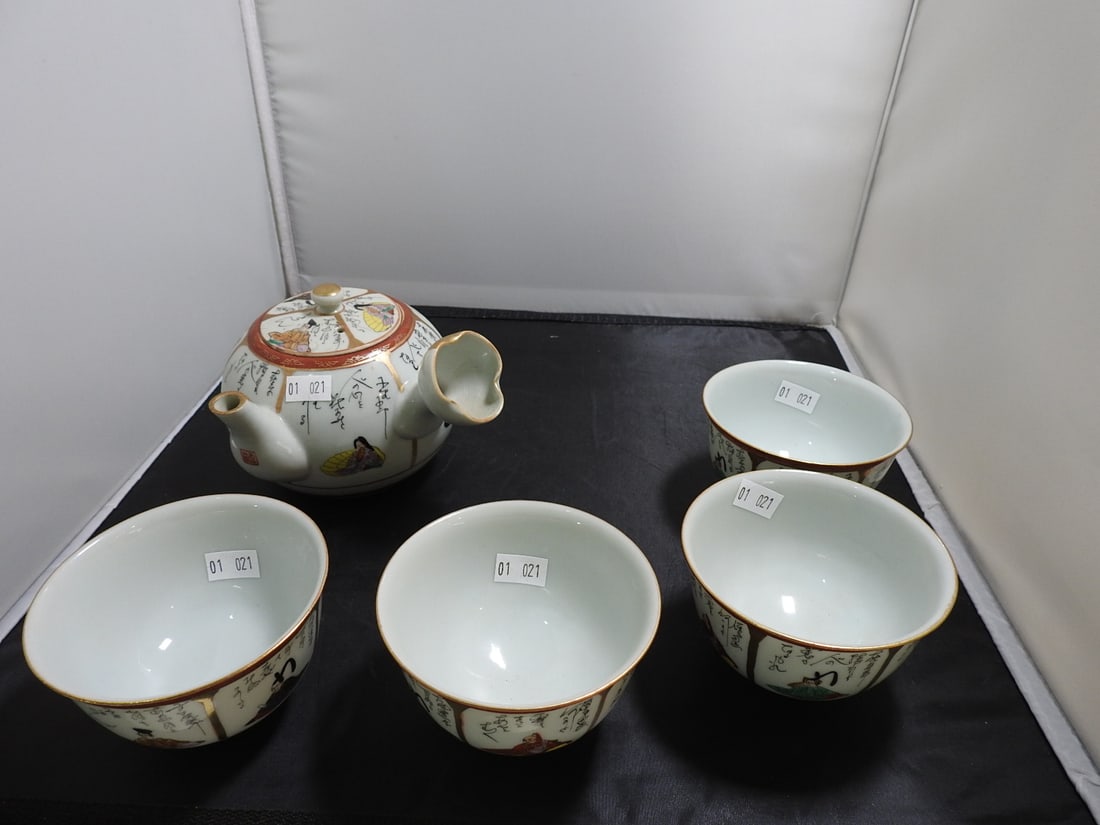 Hand-Painted Japanese Porcelain Tea Set, 6 Pieces: Hand-painted Japanese porcelain tea set with teapot, lid, and matching bowls/cups with figural and calligraphy decoration. 6 pieces including lid. Lid shows repair as photographed. Approx. 5 x 9.75 x 