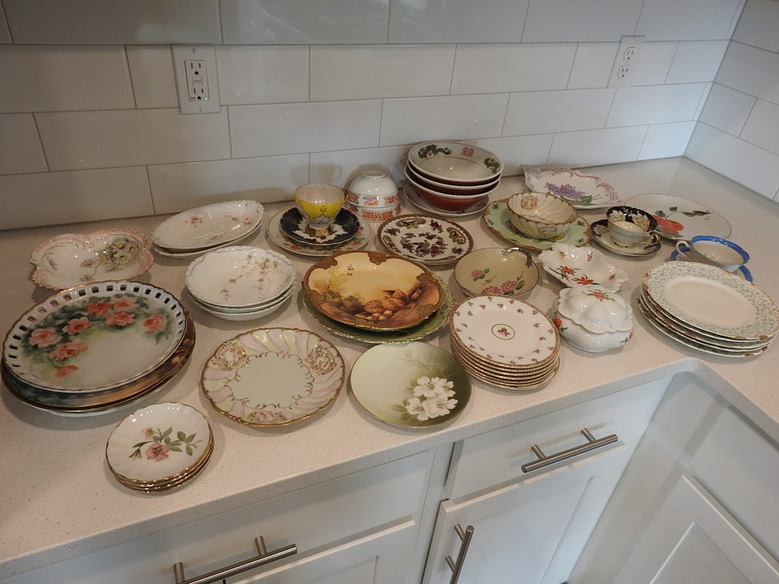 Large Mixed Porcelain and China Lot, 50 Pieces: Large 50-piece mixed porcelain and china lot, mostly hand-painted, including plates, cups, saucers, bowls, and assorted decorative pieces. Measured as packed. Approx. 30 x 30 x 30 in.