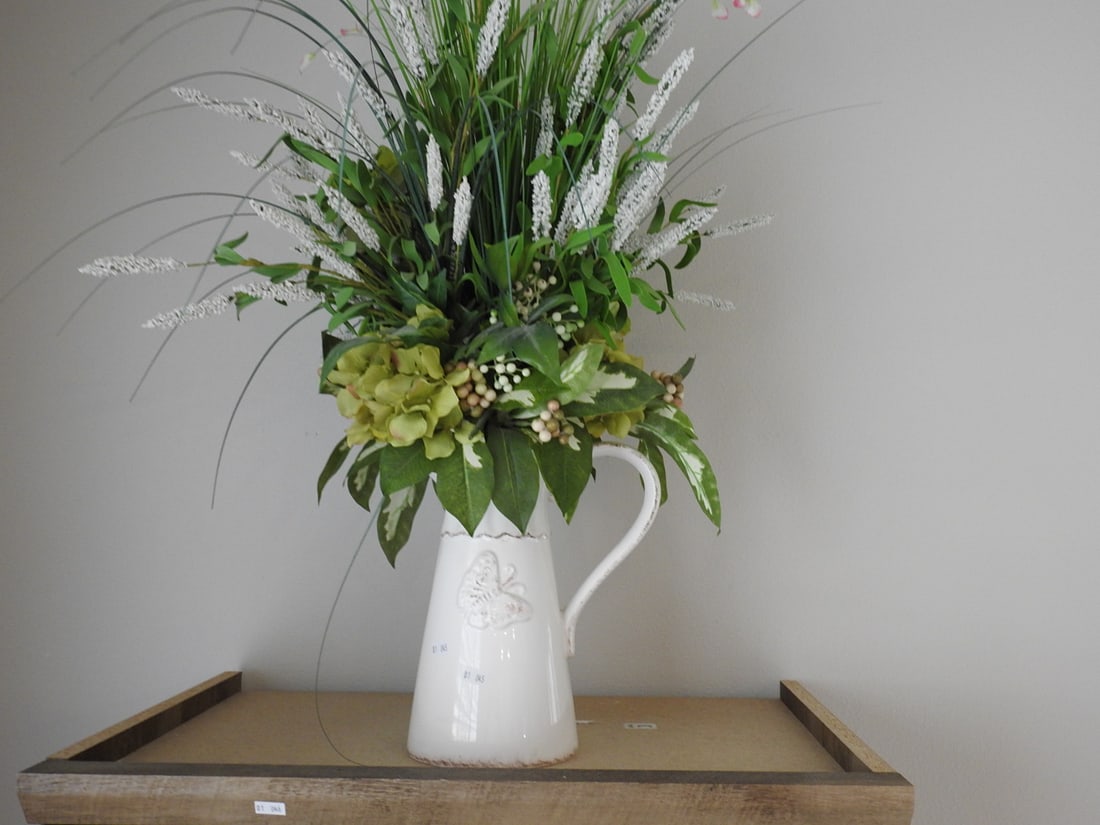 Ceramic Pitcher with Silk Floral Arrangement: Ceramic pitcher used as a vase with tall silk floral arrangement. Approx. 30 x 15 x 15 in.