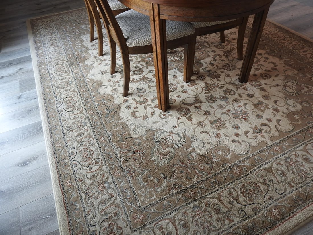 Vintage Ariana / Sphinx Round Area Rug: Vintage round area rug, label visible for Ariana by Sphinx, with floral border design. Actual size noted in dimensions. Approx. 95 x 124 x 1 in.