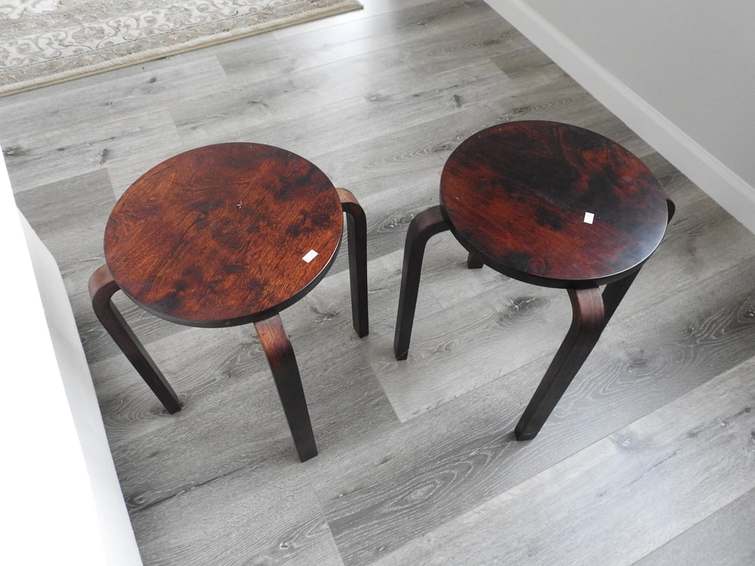 Pair of Round Wooden Stools: Pair of round wooden stools with dark legs and reddish-brown tops. Approx. 20 x 17 x 17 in.