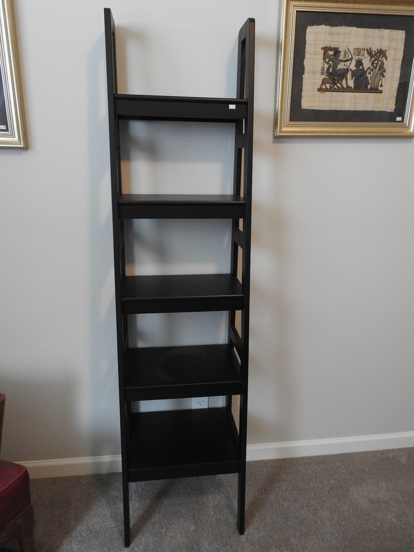 Black Wood Ladder Standing Shelf: Black wood ladder-style standing shelf with open tiered design. Approx. 69 x 17.5 x 14 in.