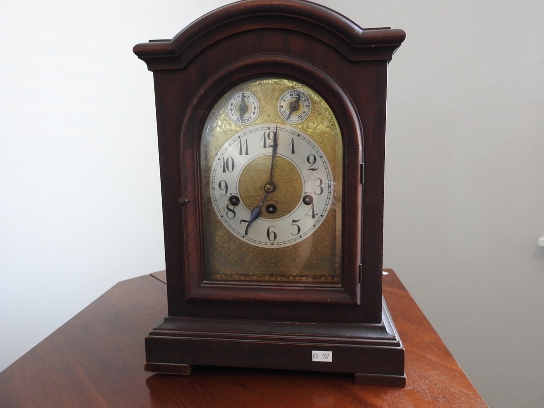 Antique Junghans Mahogany Mantel Clock with Key: Antique mahogany mantel clock by Junghans with original key and Westminster chime. Approx. 15.5 x 11 x 8 in.