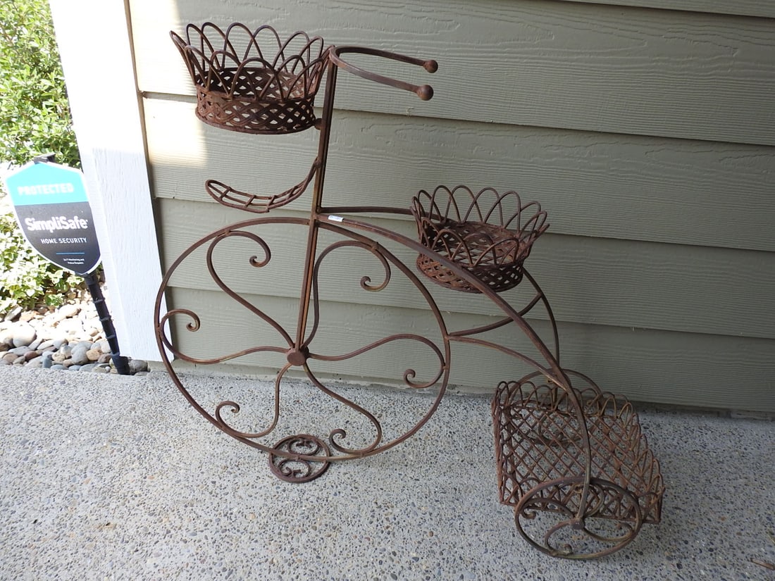 Victorian Tricycle Metal Flower Pot Holder: Victorian style metal flower pot holder in tricycle form. Approx. 27.5 x 32 x 10 in.