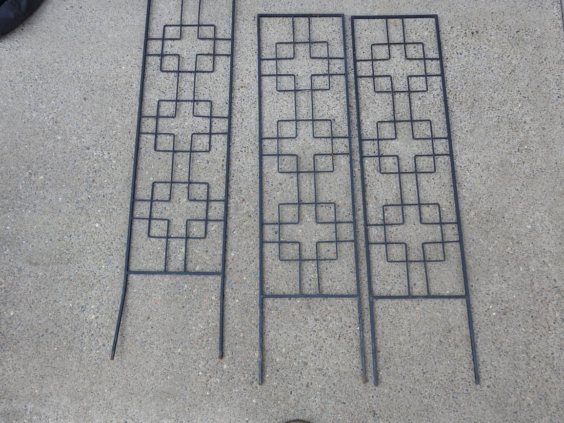 Set of Three Metal Garden Trellises: Set of three matching metal garden trellises with geometric lattice-style panels. Each measures approx. 48.5 x 12.5 x 0.5 in.