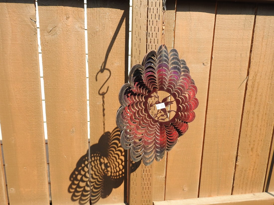 Hummingbird Metal Garden Wind Spinner: Decorative metal hummingbird garden wind spinner with multicolor flower-form spinner design and hanging hook. Approx. 10.5 x 10 x 4 in.