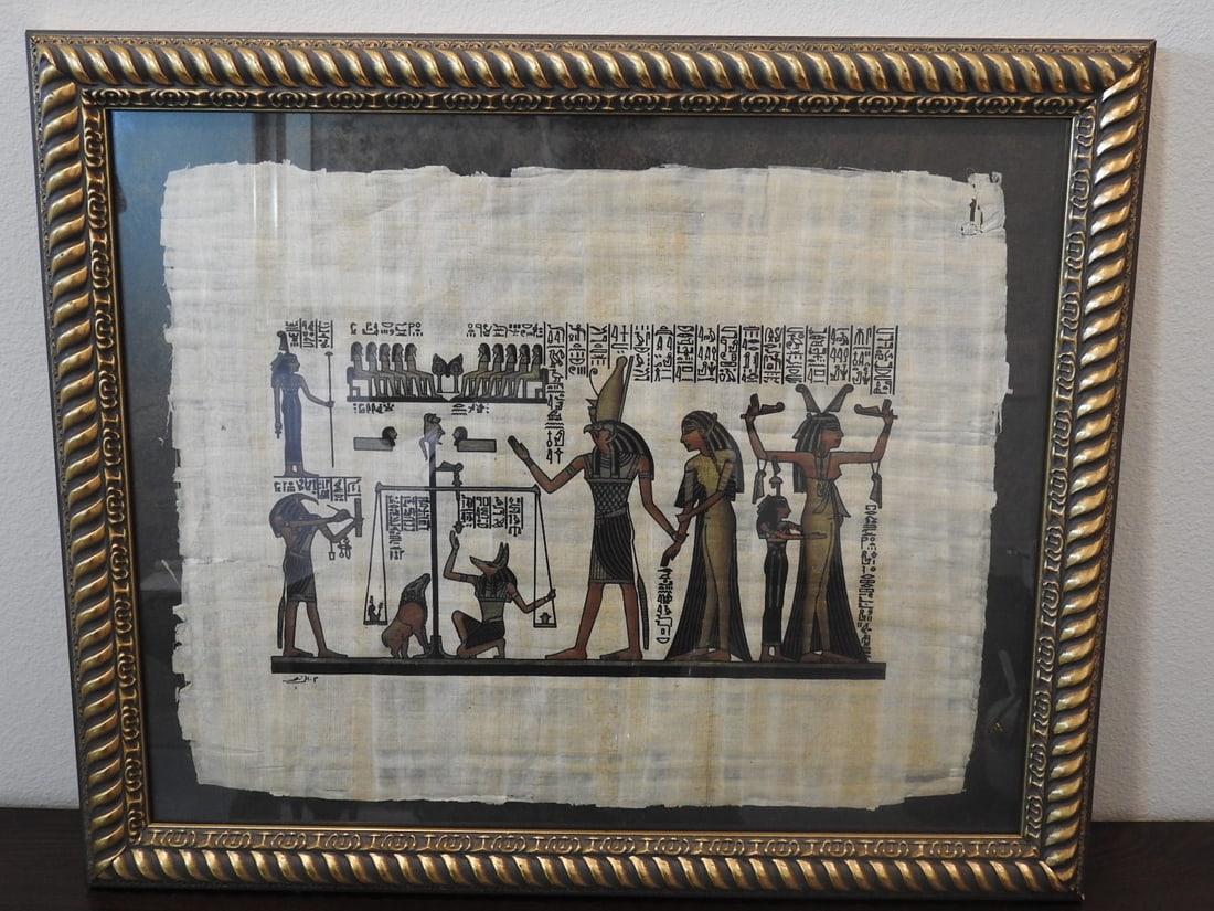 Framed Egyptian Papyrus-Style Art: Framed Egyptian papyrus-style artwork depicting figures in an Egyptian motif, measured as packed. Approx. 2 x 19 x 23 in.