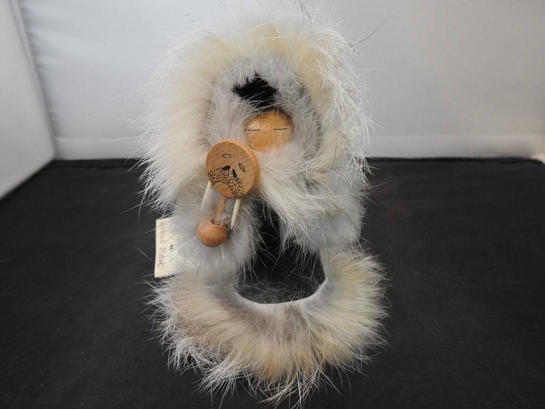 Thistleberries Handcrafted Wooden Inuit Figure: Thistleberries handcrafted wooden Inuit figure with genuine rabbit fur, measured as packed. Approx. 5 x 3 x 3 in.