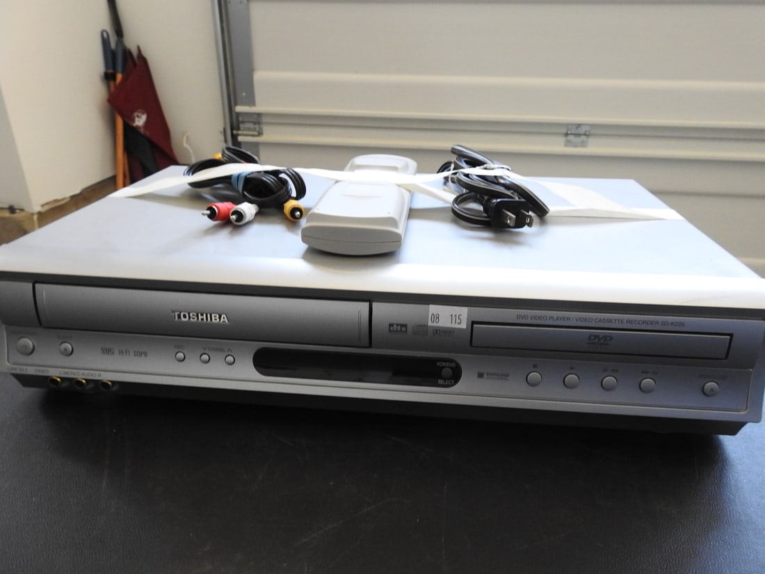 Toshiba SD-K220U DVD/VCR Deck: Toshiba SD-K220U DVD/VCR deck with cables and remote as shown, dated November 2003, measured as packed. Approx. 6 x 17 x 10 in.