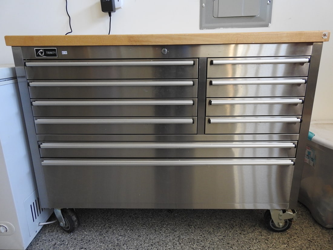 Steel Workbench Tool Chest with Solid Top: Steel workbench tool chest with solid top, drawers, casters, and stainless/steel construction, measured as packed. Approx. 38 x 52 x 19 in.