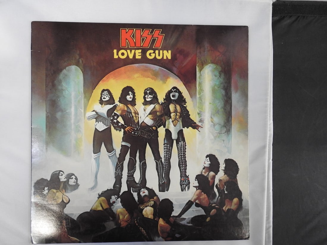KISS Love Gun Vinyl LP: KISS Love Gun vinyl LP with illustrated album cover, record and printed inner sleeve/materials as photographed.