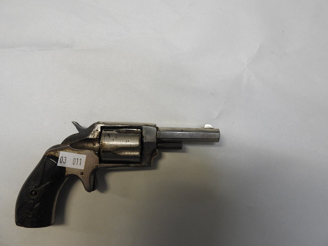 Defender Spur-Trigger Pocket Revolver – .32 Rimfire: Antique spur-trigger pocket revolver with “DEFENDER” marking visible on the top of the barrel/frame area. Spreadsheet identifies .32 Rimfire caliber, single-action operation, approximately