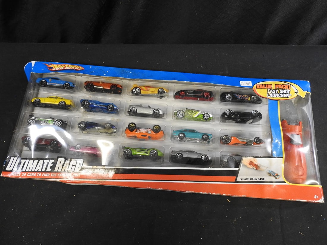 2009 Hot Wheels 20-Car Race Pack with Launcher: Hot Wheels 20-car Race Pack dated 2009 with Easy Shot Launcher, presented in the original window box. Assorted cars are visible through the packaging.